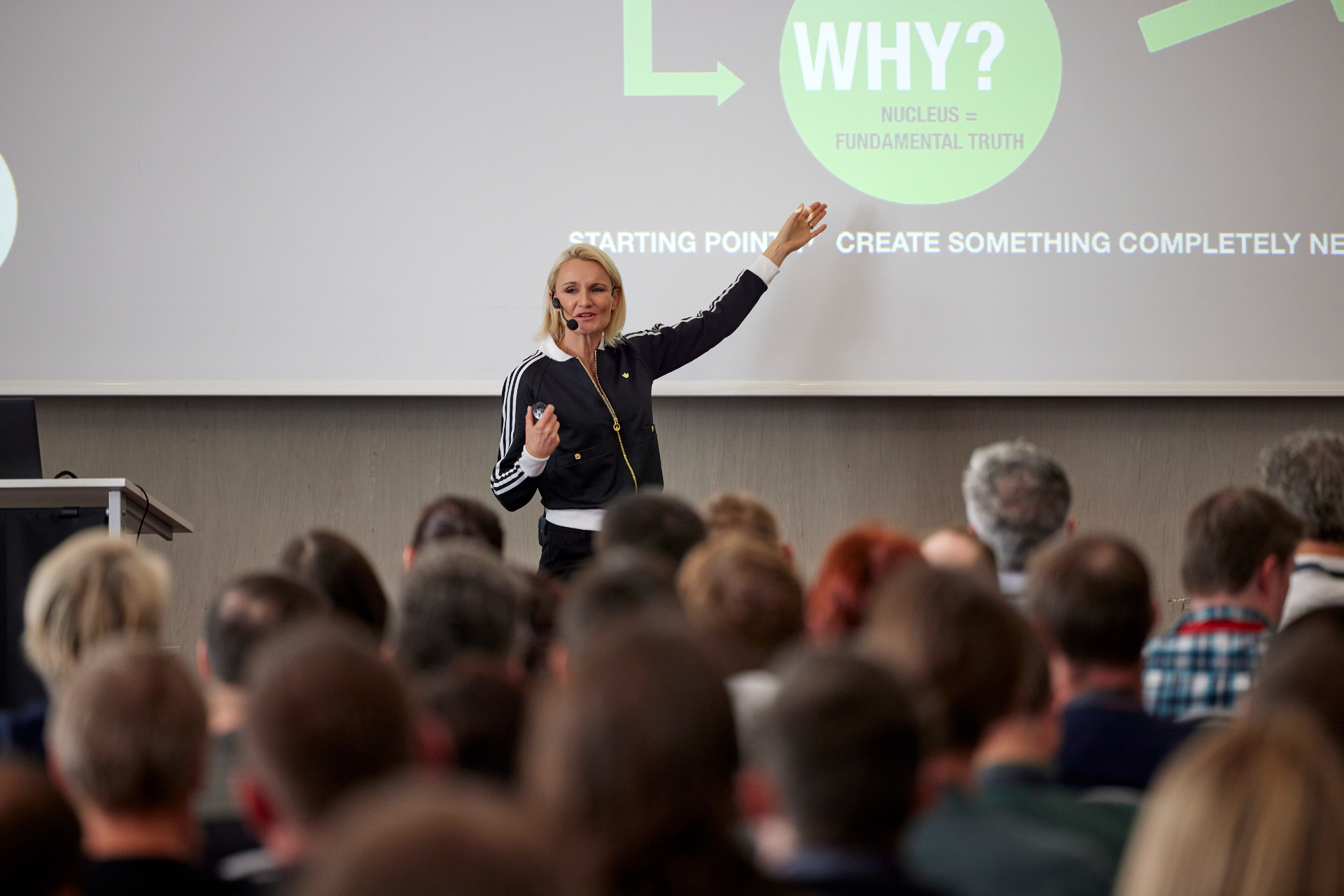 Henriette Hochstein-Frädrich presenting in front of a slide reading WHY — keynote on social media, dopamine and meaning
